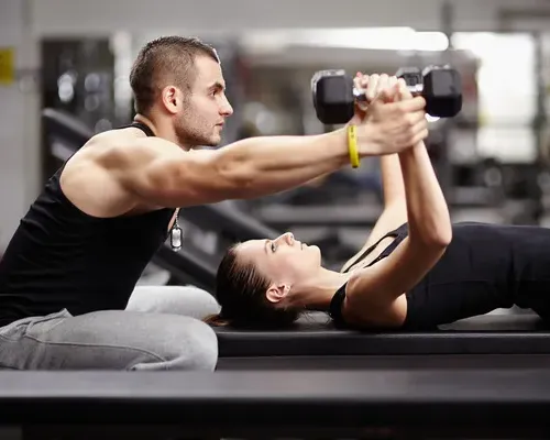 depositphotos_37800009-stock-photo-personal-trainer-helping-woman-at-2